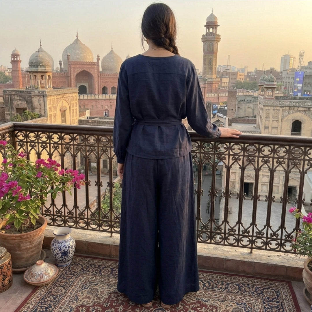 Person in a blue outfit standing on a balcony overlooking an urban landscape with domed buildings.